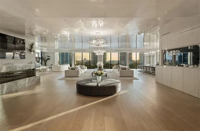 a lobby with furniture and a large window with kitchen view