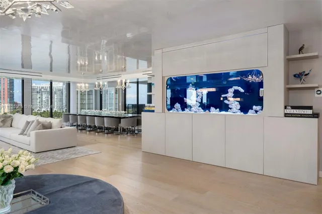 a living room with furniture and a painting on the wall