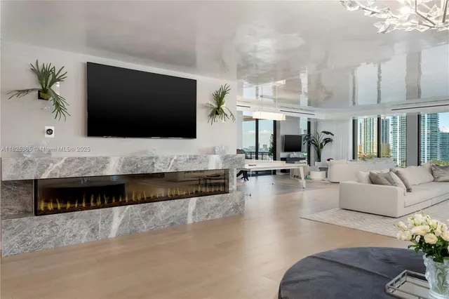 a living room with fireplace furniture and a flat screen tv