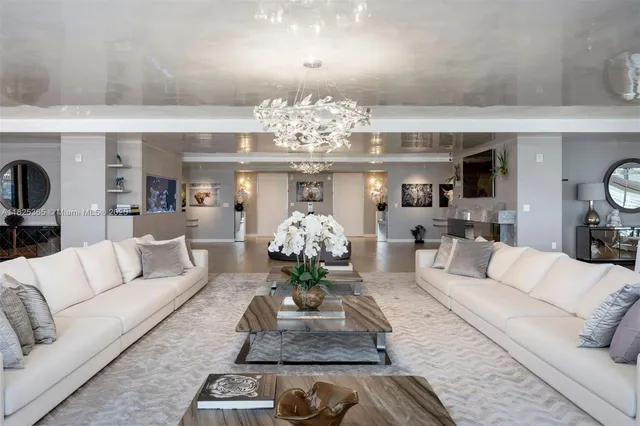 a living room with furniture and a chandelier