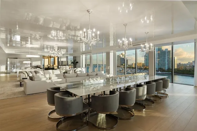 a room with lots of wooden furniture and a chandelier