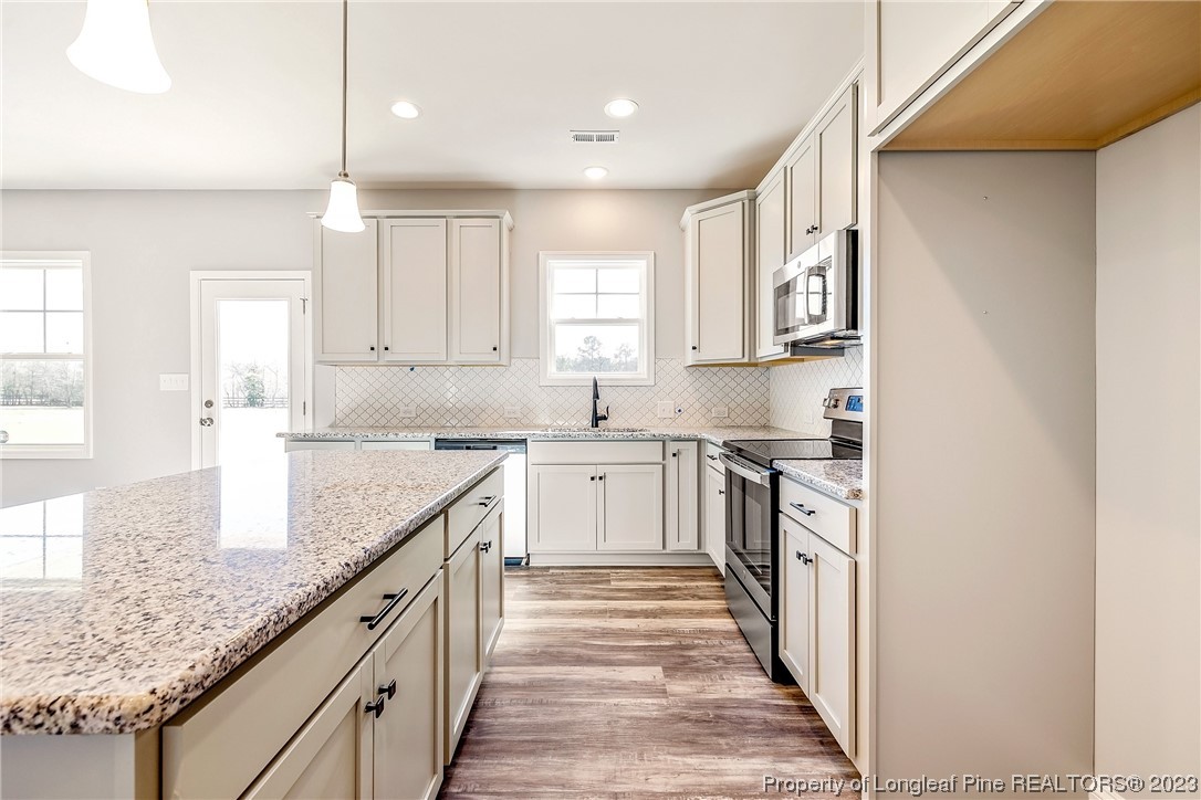 5326 Pittman Grove Church Road Raeford, NC 28376 - Photo 12 of 34 a kitchen with granite countertop a sink and cabinets