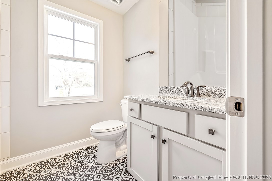 5326 Pittman Grove Church Road Raeford, NC 28376 - Photo 18 of 34 a bathroom with a sink toilet and window