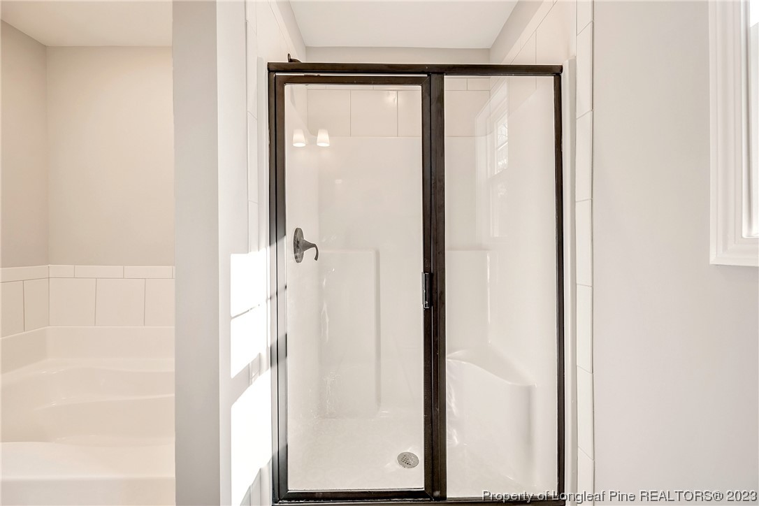5326 Pittman Grove Church Road Raeford, NC 28376 - Photo 31 of 34 a bathroom with a glass shower door