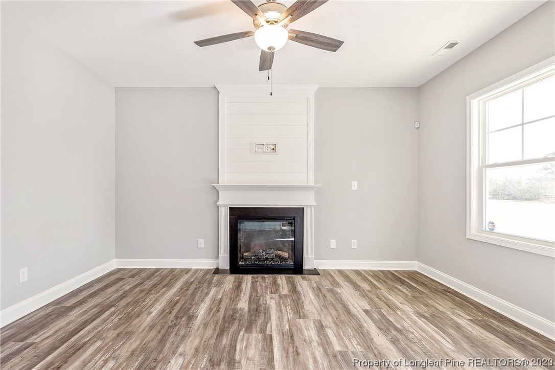 5326 Pittman Grove Church Road Raeford, NC 28376 - Photo 8 of 34 a view of empty room with a fireplace and wooden floor