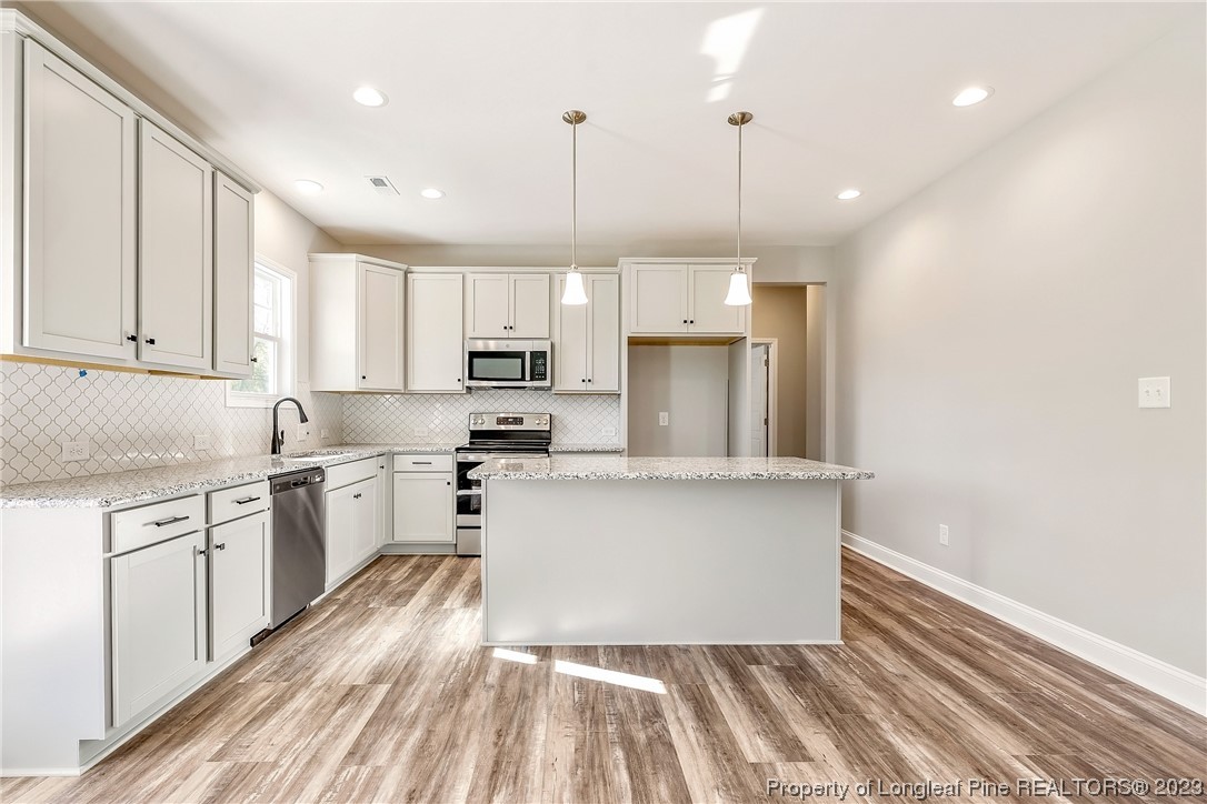 5326 Pittman Grove Church Road Raeford, NC 28376 - Photo 10 of 34 a kitchen with cabinets and wooden floor