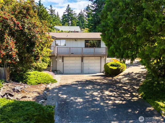 a view of a house with a small yard and a plants