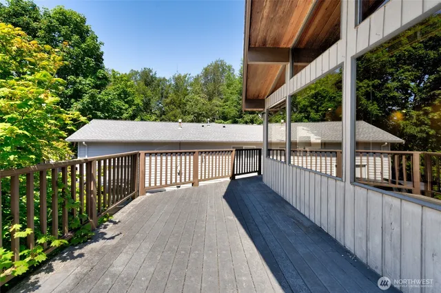 a view of balcony with wooden floor and seating space