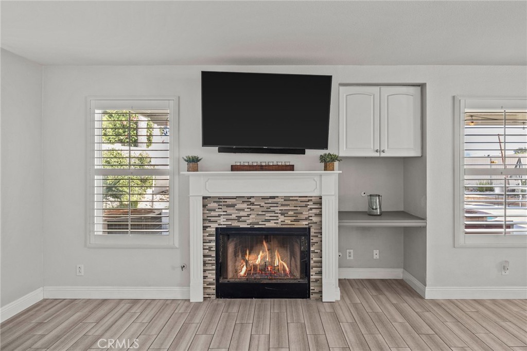 8992 Dahlia Drive Corona, CA 92883 - Photo 13 of 38 a living room with a fireplace and a flat screen tv