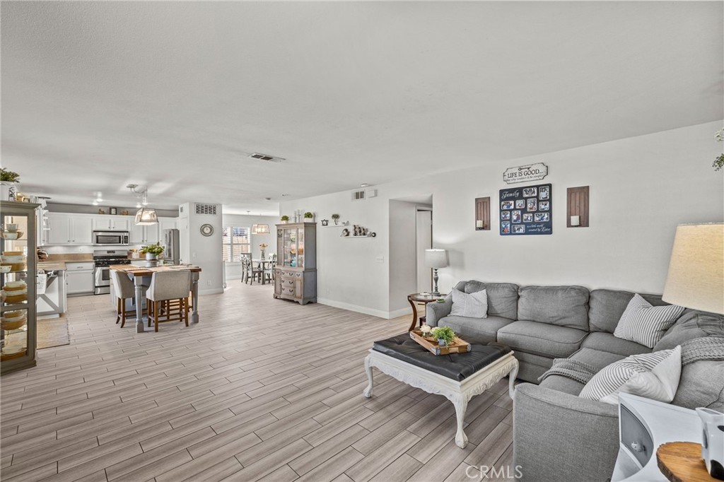 8992 Dahlia Drive Corona, CA 92883 - Photo 15 of 38 a living room with furniture and view of kitchen