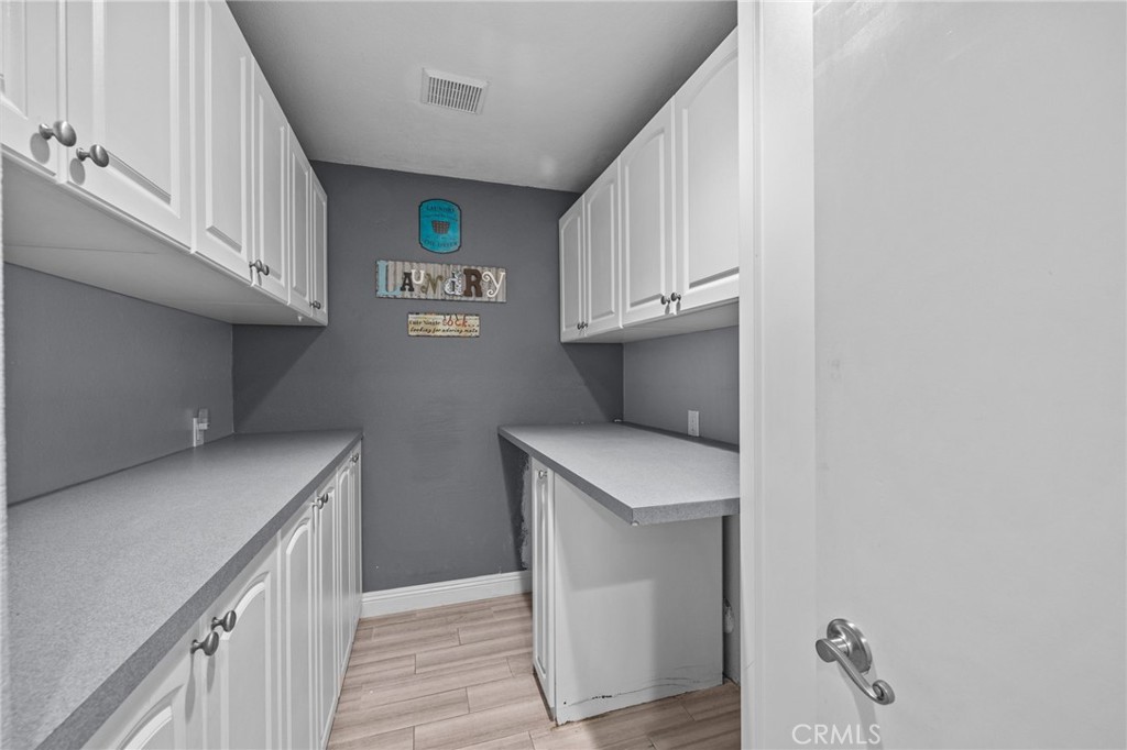 8992 Dahlia Drive Corona, CA 92883 - Photo 16 of 38 a utility room with cabinets washer and dryer