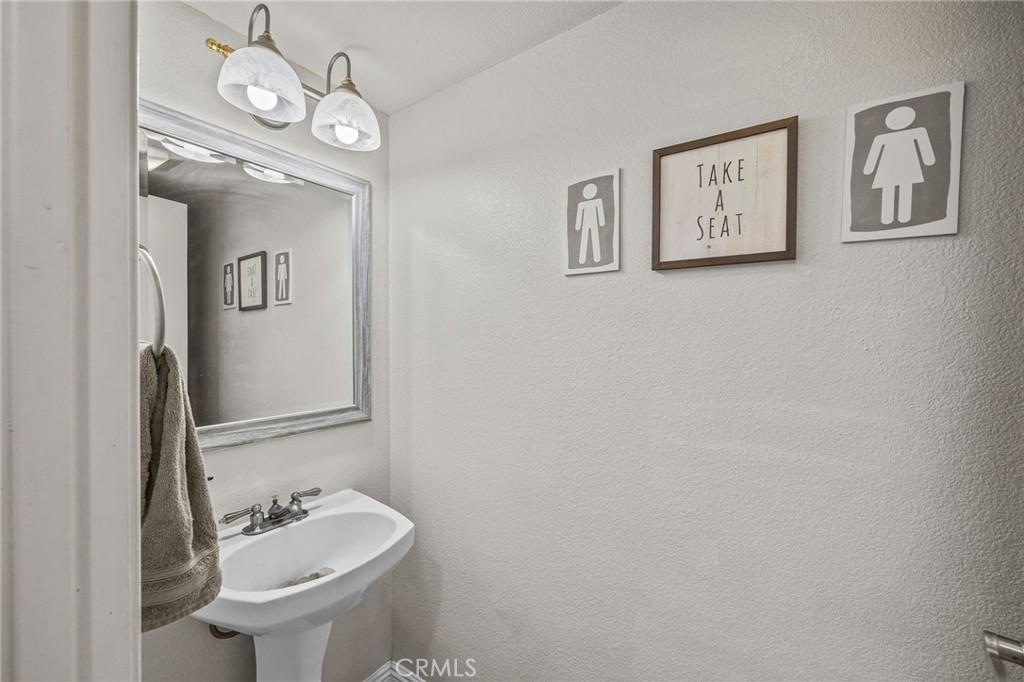 8992 Dahlia Drive Corona, CA 92883 - Photo 17 of 38 a bathroom with a sink and a mirror