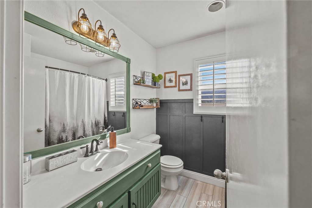 8992 Dahlia Drive Corona, CA 92883 - Photo 20 of 38 a bathroom with a sink a toilet and a mirror