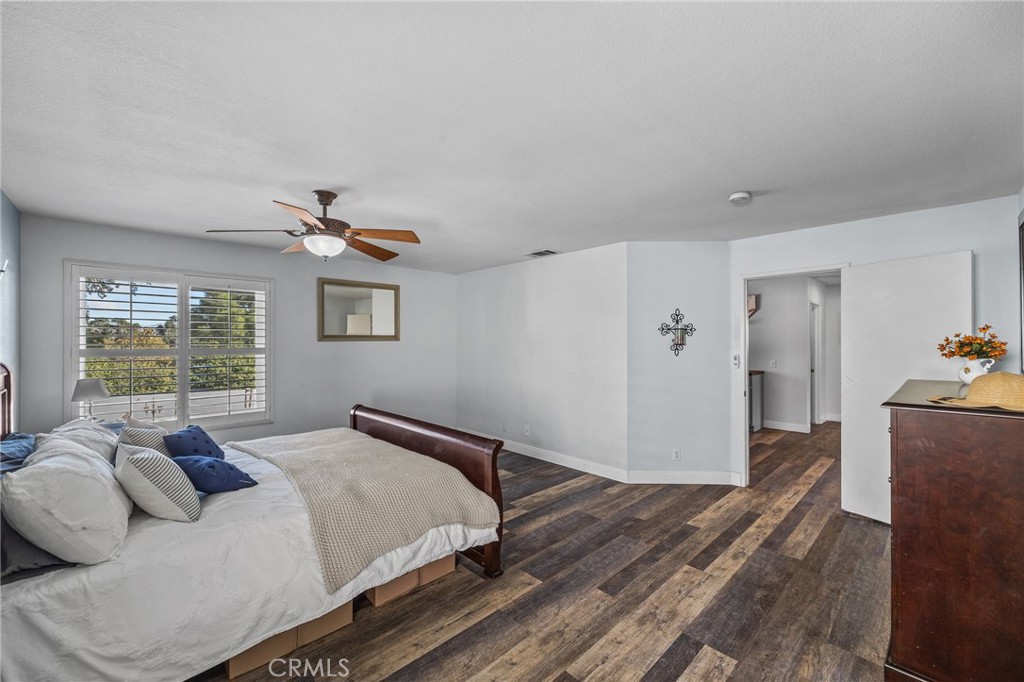 8992 Dahlia Drive Corona, CA 92883 - Photo 26 of 38 a bedroom with a bed and wooden floor