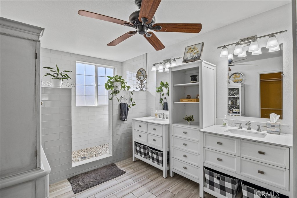 8992 Dahlia Drive Corona, CA 92883 - Photo 28 of 38 a spacious bathroom with a double vanity sink and a mirror