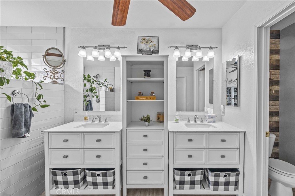 8992 Dahlia Drive Corona, CA 92883 - Photo 29 of 38 a bathroom with a double vanity sink and a mirror