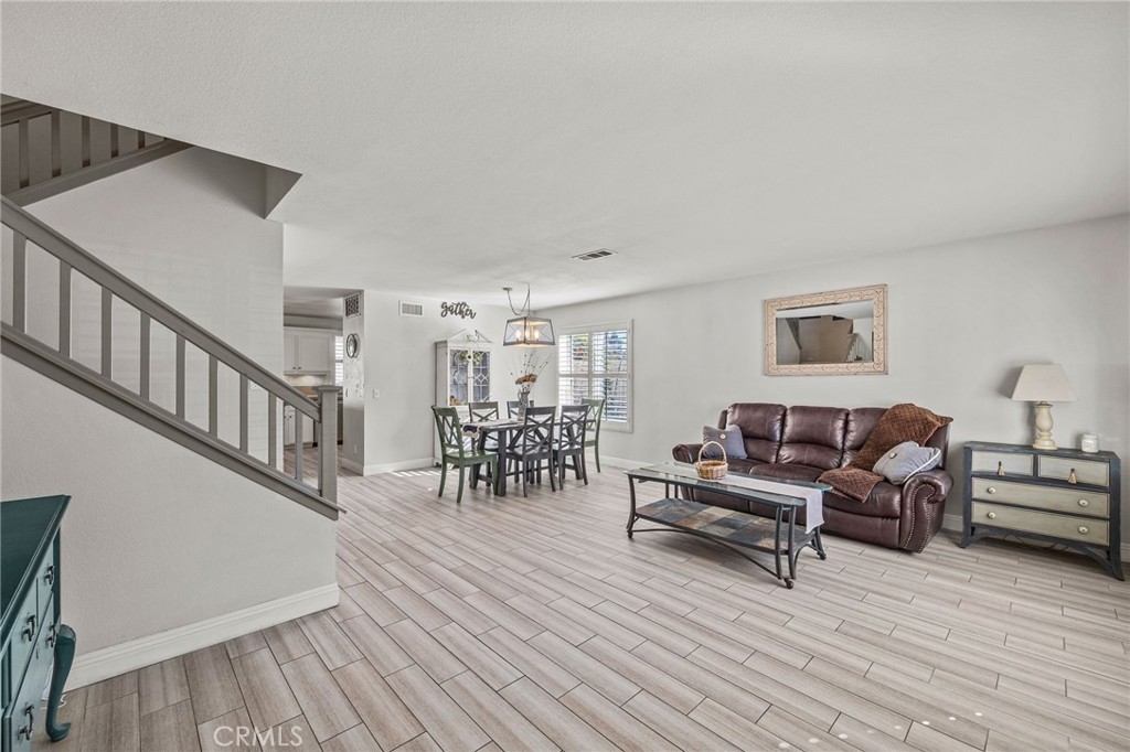 8992 Dahlia Drive Corona, CA 92883 - Photo 3 of 38 a living room with furniture and a wooden floor