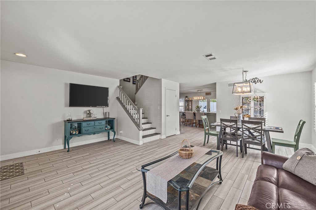 8992 Dahlia Drive Corona, CA 92883 - Photo 4 of 38 a living room with furniture a flat screen tv and a wooden floor