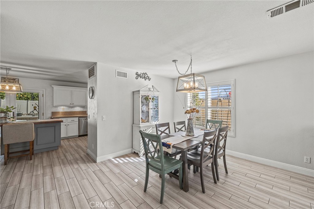 8992 Dahlia Drive Corona, CA 92883 - Photo 6 of 38 a view of a dining room with furniture and wooden floor