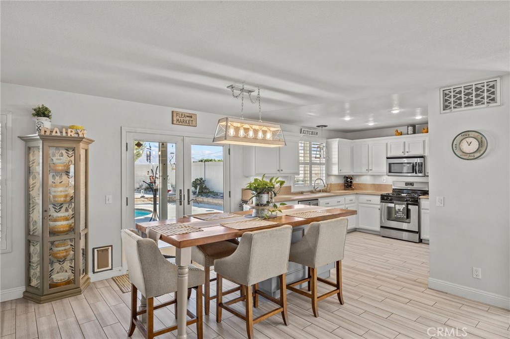 8992 Dahlia Drive Corona, CA 92883 - Photo 10 of 38 a view of a dining room with furniture and wooden floor