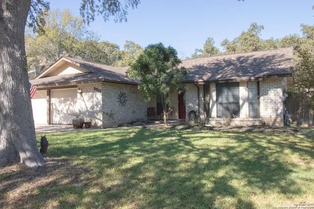 a view of a house with backyard porch and sitting area