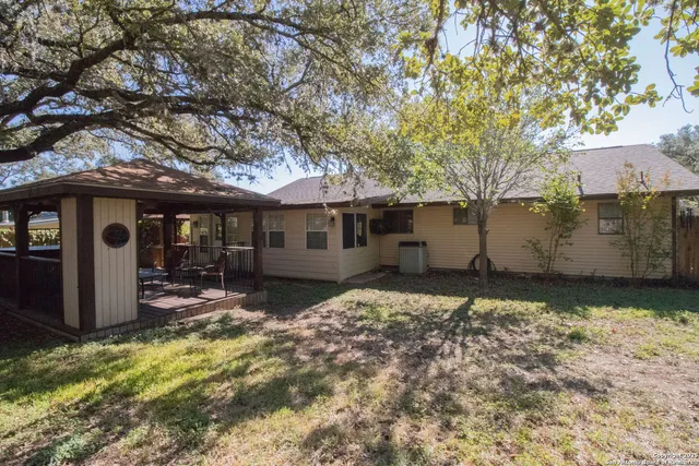 a view of a house with a large tree