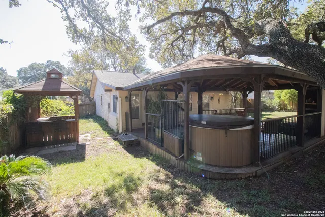 a view of a patio with table and chairs under an umbrella