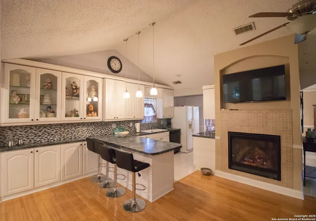 a kitchen with a sink a microwave and cabinets