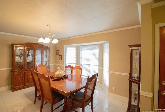 a view of a dining room with furniture and chandelier