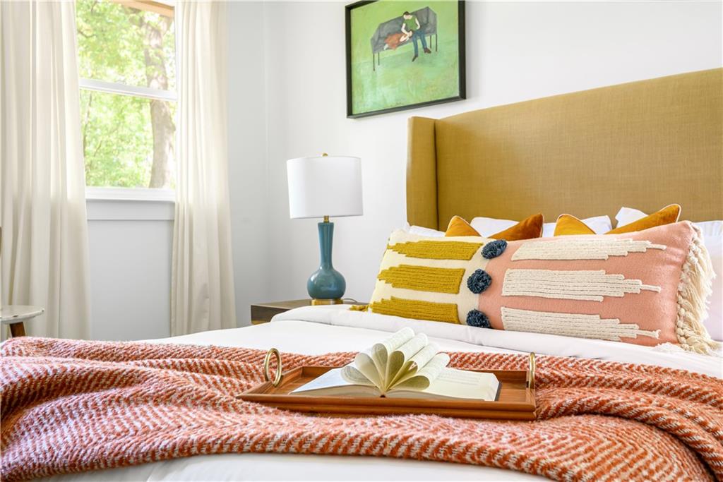 347 Sinclair Avenue Northeast Atlanta, GA 30307 - Photo 18 of 32 a bedroom with a bed and a painting on the wall