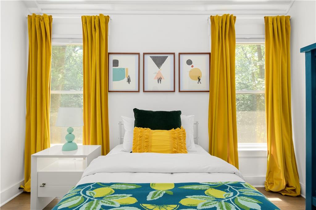 347 Sinclair Avenue Northeast Atlanta, GA 30307 - Photo 22 of 32 a bedroom with a bed and wooden floor