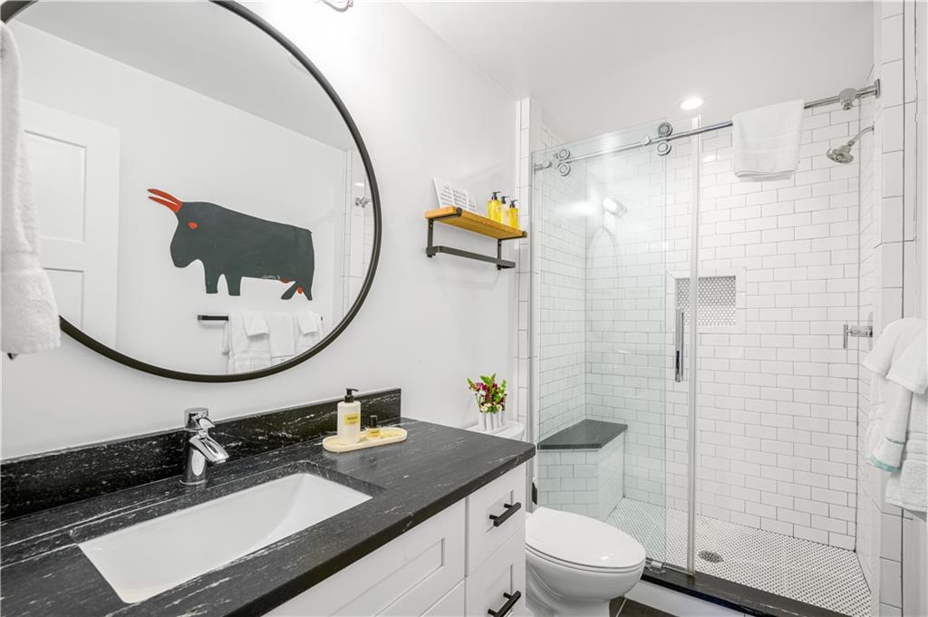 347 Sinclair Avenue Northeast Atlanta, GA 30307 - Photo 26 of 32 a bathroom with a sink a toilet and a mirror
