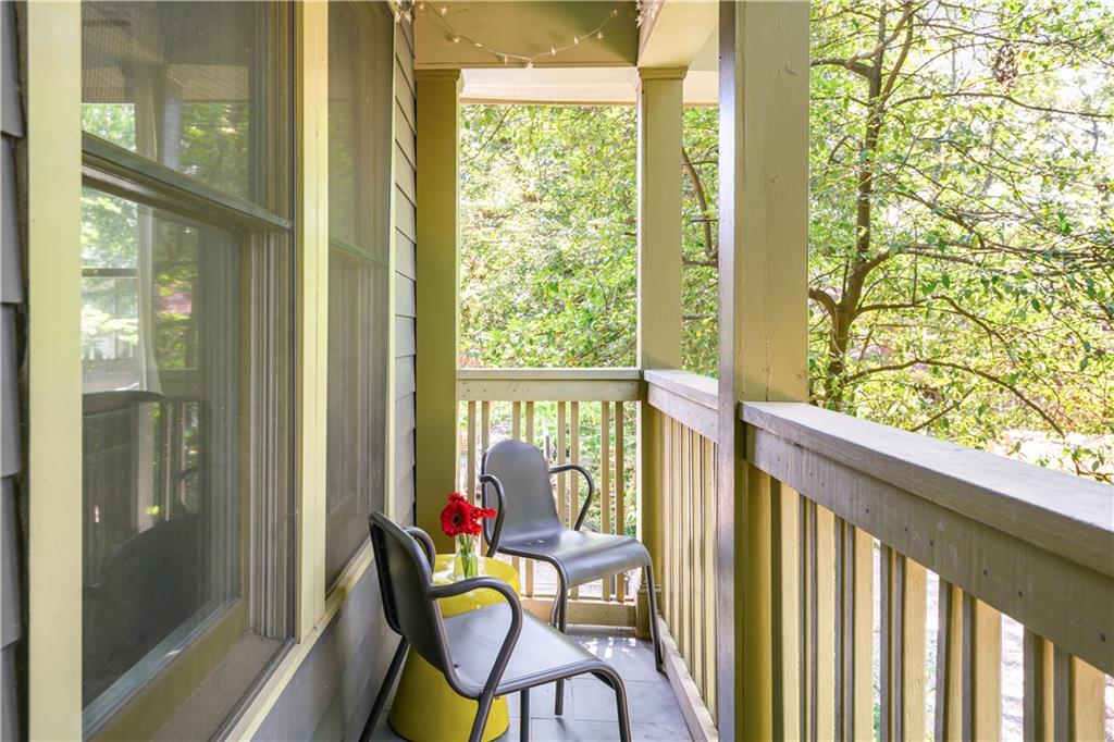 347 Sinclair Avenue Northeast Atlanta, GA 30307 - Photo 31 of 32 a view of a balcony with chairs and table in front of glass door