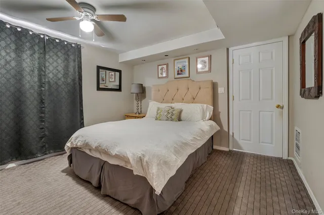 a bathroom with a sink a toilet a mirror and shower curtain