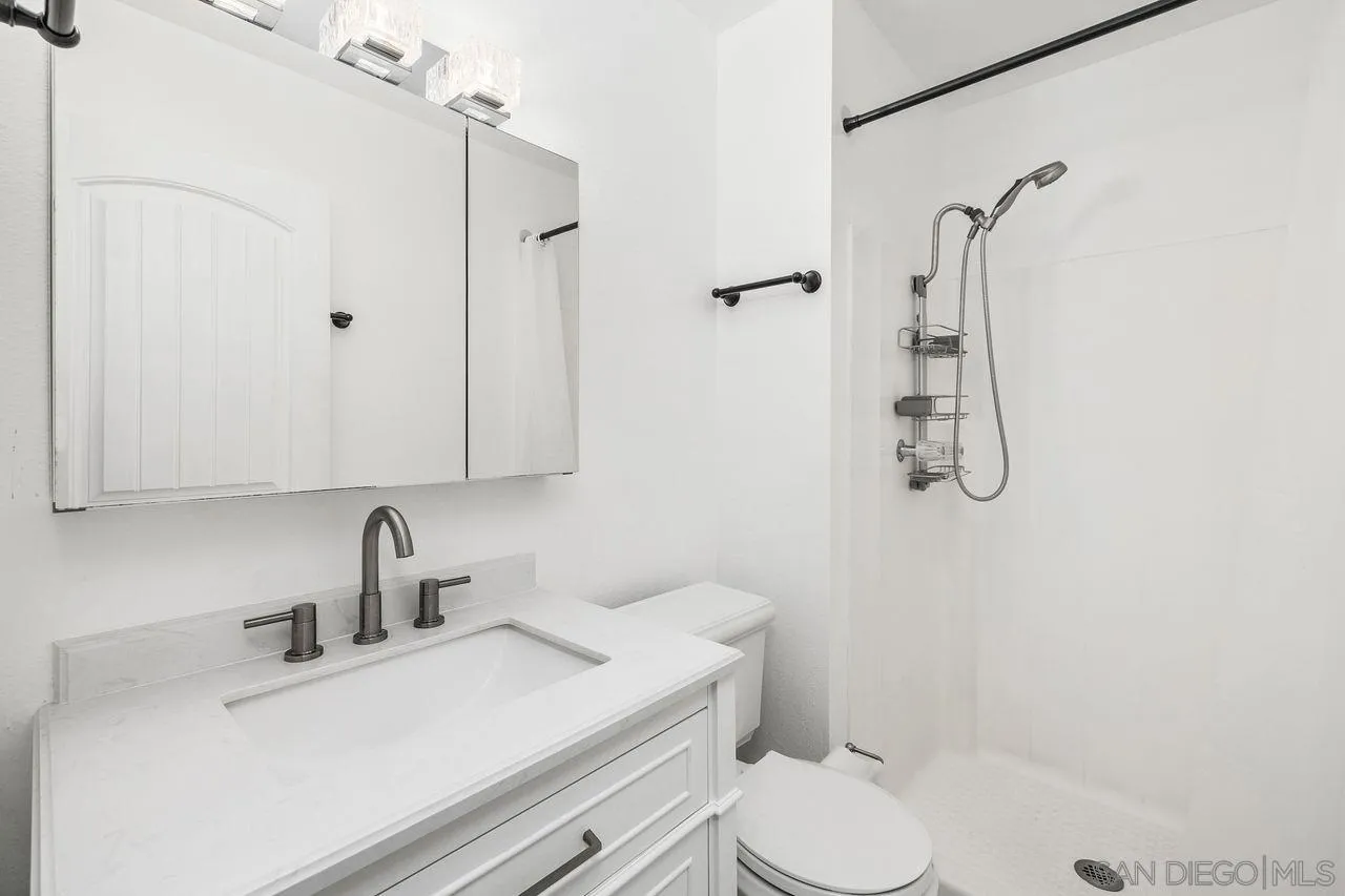 14215 Sutter Mill Way Poway, CA 92064 - Photo 11 of 38 a bathroom with a sink toilet and shower