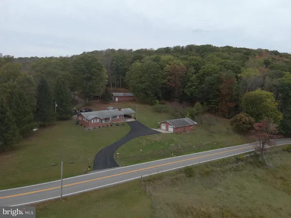 an aerial view of a residential houses with outdoor space