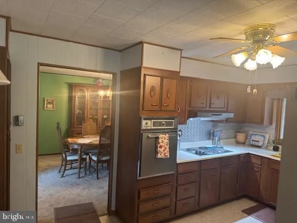 a bed sitting in a bedroom next to a window and a wooden floor