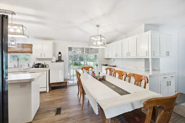 a view of kitchen with cabinets and wooden floor
