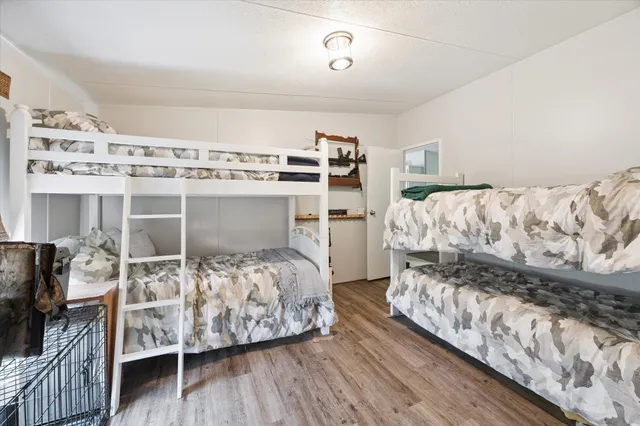 a bedroom with a bed and a flat tv screen on dresser