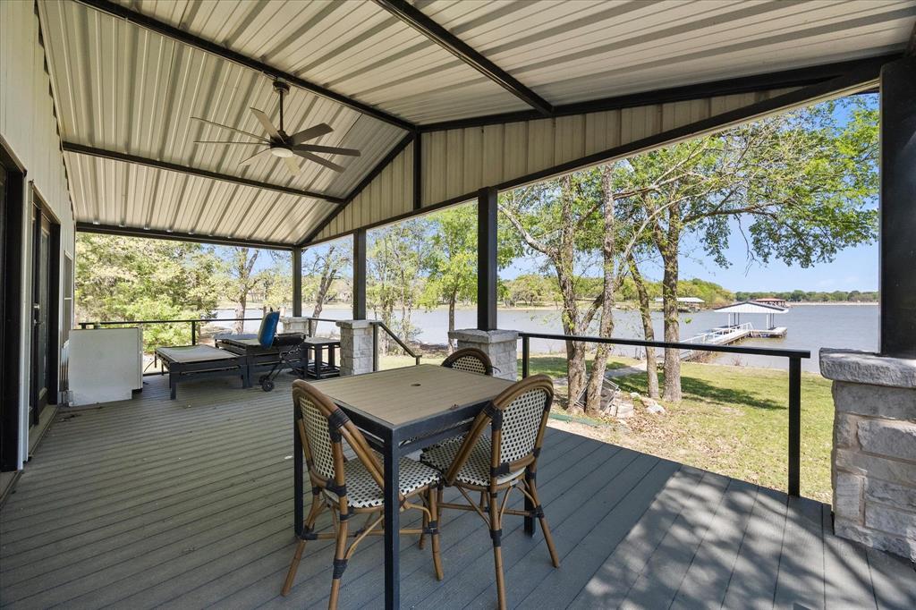 2776 Waters Edge Quinlan, TX 75474 - Photo 17 of 28 a view of a patio with table and chairs and wooden floor