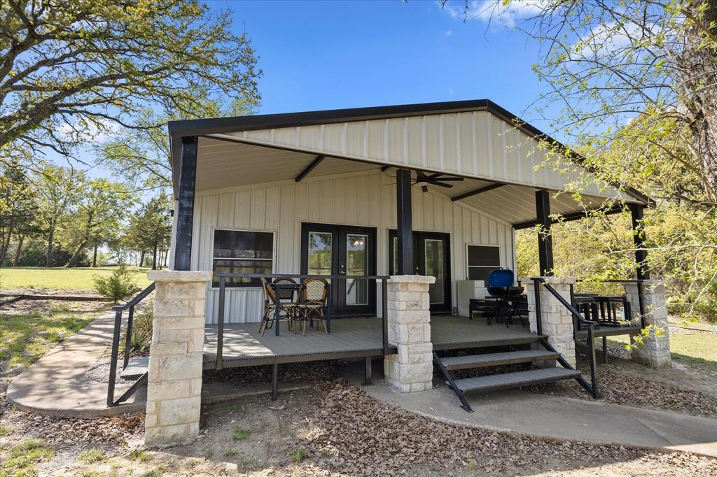 2776 Waters Edge Quinlan, TX 75474 - Photo 18 of 28 a patio with glass top table and chairs