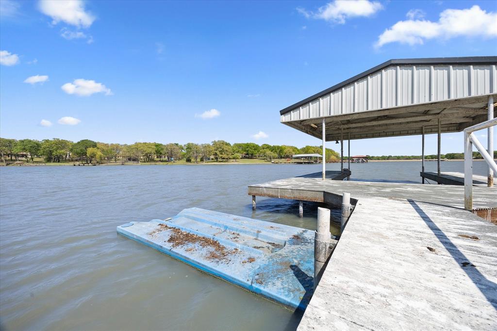 2776 Waters Edge Quinlan, TX 75474 - Photo 21 of 28 a view of a lake with a deck and a yard