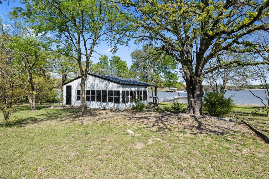 2776 Waters Edge Quinlan, TX 75474 - Photo 25 of 28 a house with trees in front of it