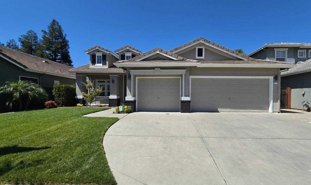 2219 Autumn Moon Way Turlock, CA 95382 - Photo 1 of 1 a front view of a house with garden