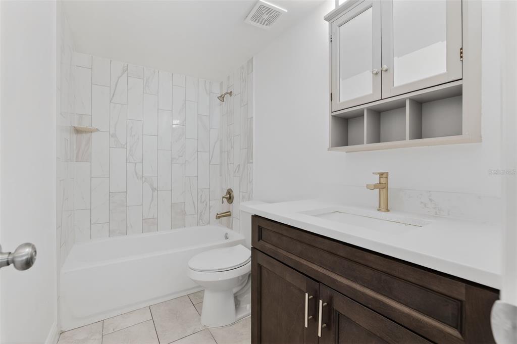 10914 Leeds Road Port Richey, FL 34668 - Photo 6 of 24 a bathroom with a sink a toilet and shower