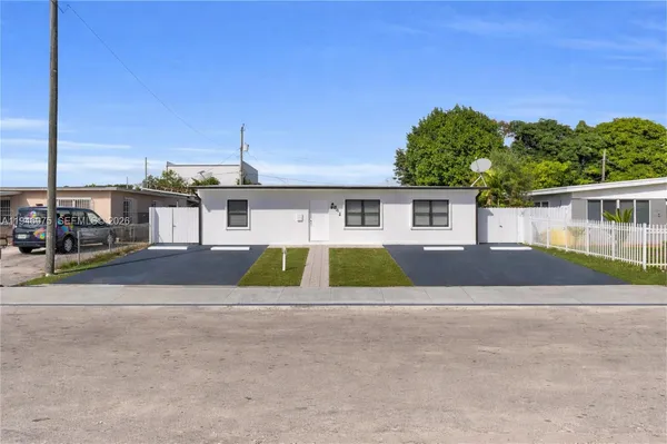 front view of a house next to a yard