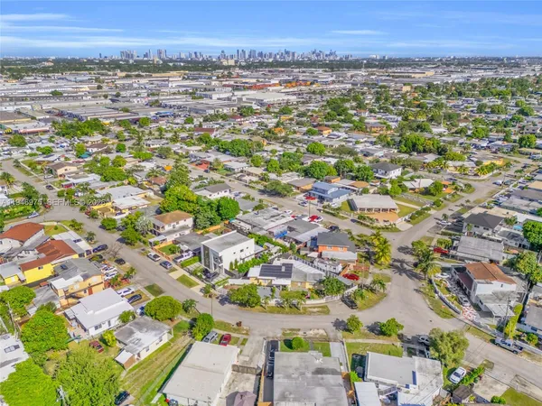 a view of a house with a backyard and garage
