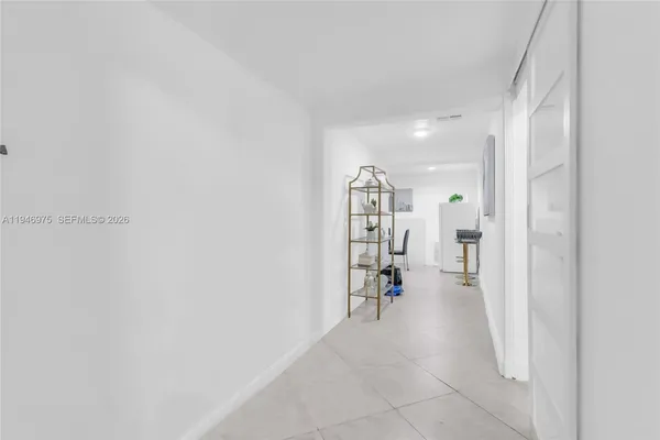 a kitchen with granite countertop stainless steel appliances a refrigerator sink and cabinets