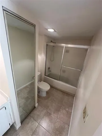 a bathroom with a shower and a toilet