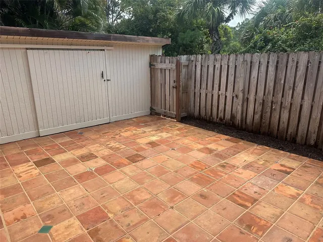 a view of backyard with wooden fence